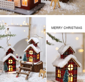 Macro view of plaid Christmas cabin ornaments with warm LED light and faux snow details