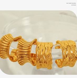 Detailed view of 18K gold plated earrings featuring French ripple texture and C-shape design