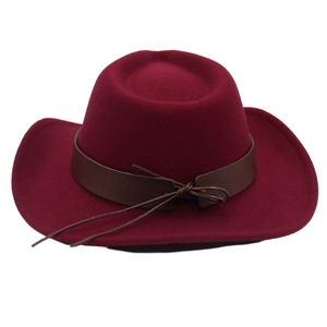 Detail of burgundy western cowboy hat with brown leather belt and decorative string