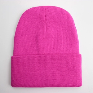 Detailed close-up of rose pink beanie featuring premium knitted texture for winter warmth