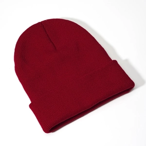 Detail view of burgundy acrylic knit beanie showing fine ribbed texture and folded cuff