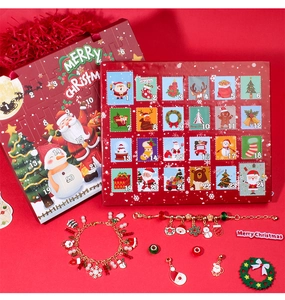 Detail of Christmas advent calendar box with golden DIY bracelets and 22 festive charms