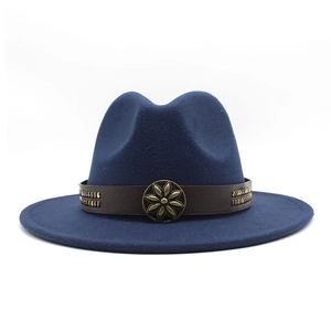 Detail of dark blue wool felt fedora with brown leather band and bronze floral badge