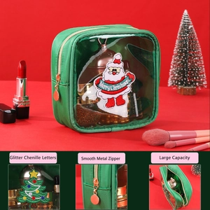 Detail view of green Christmas makeup bag with glitter chenille patches and smooth zipper