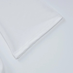 Detail of high-quality double-needle stitching on white long sleeve dress hemline