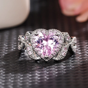 Macro shot of a heart-shaped pink gemstone ring with intricate micro-pave diamond details