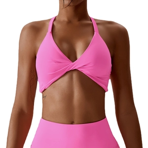 Pink halter yoga bra with cross-knot detail and high-waist sports top for fitness