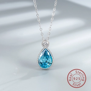 Macro shot of S925 sterling silver necklace with blue teardrop crystal and round zircon