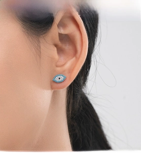 Detailed close-up of s925 silver evil eye stud earring with turquoise and white crystals