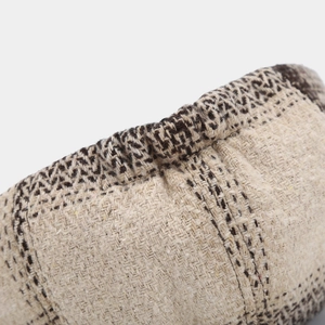 Detailed close-up of retro twill fabric and stitching on a beige newsboy hat