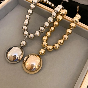 Statement chunky metal ball necklace with large polished hemispherical pendant in gold and silver