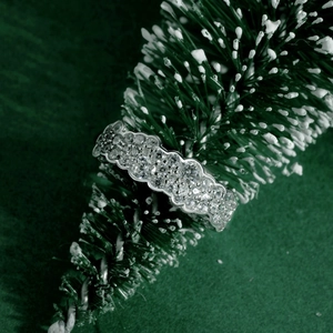 Macro detail of silver S925 ring with pavé zircons on a festive Christmas tree branch