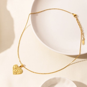 18k gold plated stainless steel heart pendant necklace with daisy engraving on white tray