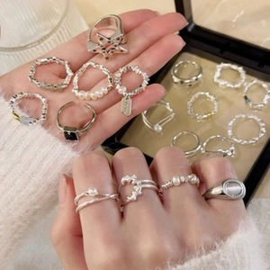 Detailed collection of 925 silver rings with pearls and star designs in a display box