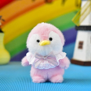 Macro view of cute pink penguin plush charm featuring a delicate lace collar and bow
