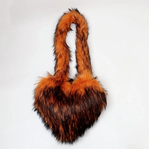 Detail of heart-shaped faux fur handbag featuring realistic animal stripes and soft texture