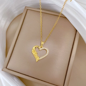 Detailed view of a gold heart pendant necklace with shimmering crystals on an elegant display