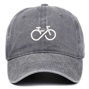 Detailed close-up of bicycle embroidery on a washed dark grey cotton baseball cap