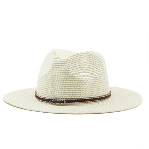 Detail of woven straw fedora hat featuring a brown ethnic ribbon and metal buckle