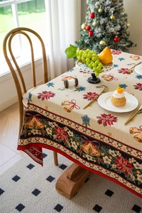 Macro view of Christmas jacquard tablecloth with poinsettia pattern and holiday decor