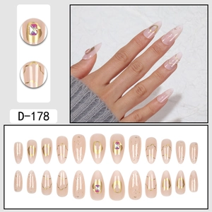 Almond fake nails featuring gold foil gradients and colorful rhinestones in a full 24pc set