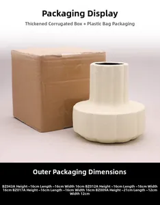 Detail of cream ceramic vase with ribbed design and reinforced cardboard packaging box