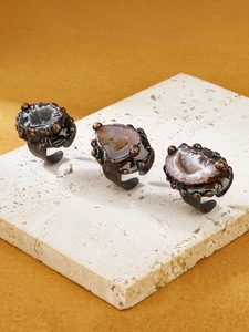 Detailed view of handcrafted antique bronze adjustable rings with natural druzy agate