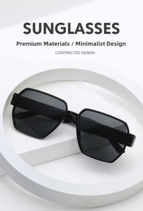 Detail of bold black geometric sunglasses temple on white studio props