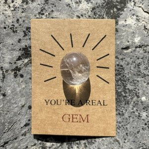 Close-up of healing crystal gem on kraft paper gift card with You are a Real Gem text