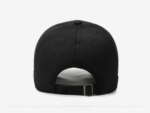 Detail view of the black baseball cap back with adjustable metal buckle and textured fabric