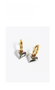 Detailed close-up of vintage heart drop earrings with mixed gold and silver finish