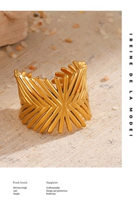 Macro detail of 18K gold plated geometric open ring with radial line texture