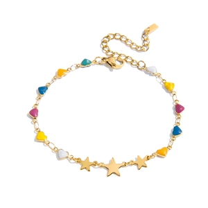 Macro detail of gold stainless steel bracelet featuring colorful enamel hearts and stars