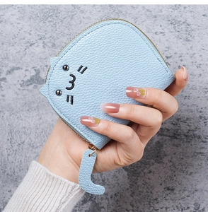 Detail of light blue cat coin purse showing lychee grain texture and cat tail zipper pull