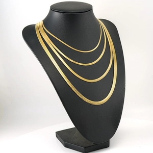 Multi-layer gold snake chain necklace displayed on a black bust mannequin in punk style