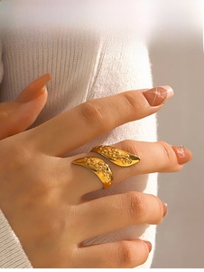 Detail of a vintage 18k gold plated stainless steel ring with 3D floral embossing on finger