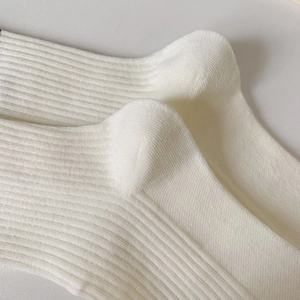 Macro shot of fine ribbed cotton sports socks showing detailed heel and ankle texture