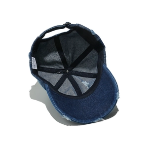 Internal detail of distressed denim baseball cap showing sweatband and stitching