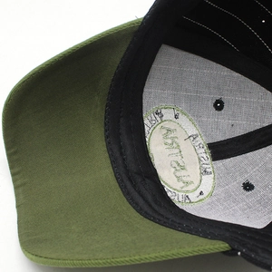 Detailed macro view of olive green cotton baseball cap with breathable white lining