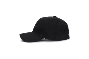 Detail view of black twill cotton baseball cap with white abstract embroidery on front