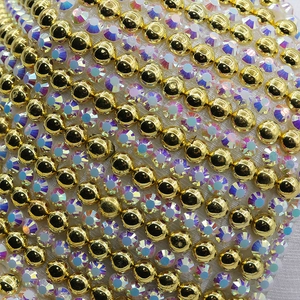 Detail of baseball cap with white fabric, golden beads and iridescent rhinestones