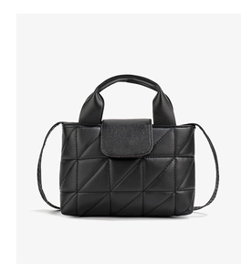 Close-up of black quilted PU leather texture and metal buckle on women's mini handbag
