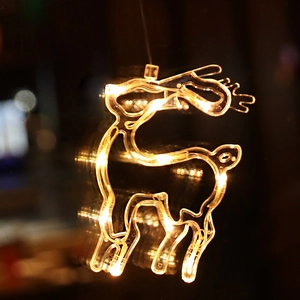 Reindeer shaped LED hanging light with warm yellow glow for window and room decoration