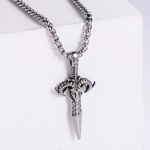 Detailed close-up of retro silver goat head sword pendant with black oxidized steel finish