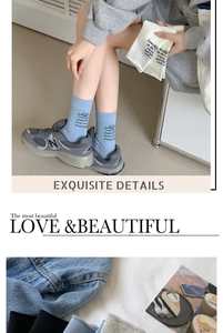 Detail of breathable cotton crew socks featuring letter print and elastic ribbed cuffs
