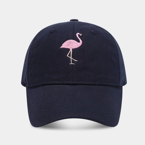 Close-up of pink flamingo embroidery detail on a navy blue twill cotton baseball cap