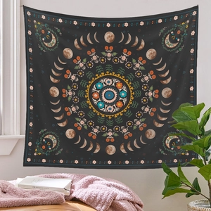 Detail view of Bohemian moon phase tapestry with floral mandala pattern on charcoal background