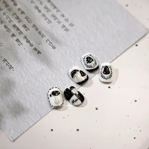 Macro view of black and white mushroom nail art stickers with hand-drawn heart details