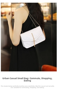 Close-up of white quilted crossbody bag with gold chain strap and tassel detail