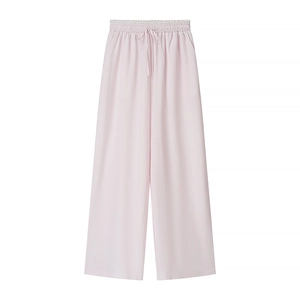 Detail of light pink wide-leg trousers featuring elastic drawstring waist and vertical texture